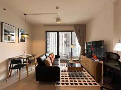 a living room with a couch and a table at 500m to BTS l Large 50 sqm l Workspace l By Sontana in Bangkok