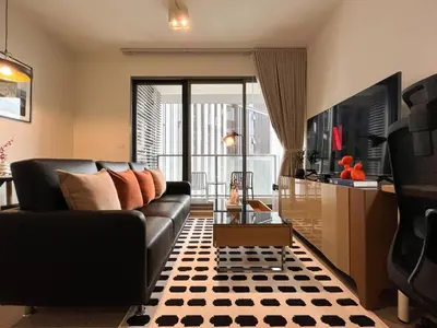 a living room with a couch and a table at 500m to BTS l Large 50 sqm l Workspace l By Sontana in Bangkok