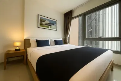 a bedroom with a large bed and a window at 500m to BTS l Large 50 sqm l Workspace l By Sontana in Bangkok