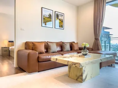 a living room with a couch and a coffee table at Near BTS l Central Sukhumvit l Pool and Garden l Sontana in Bangkok