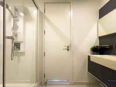 a shower with a glass door in a bathroom at Near BTS l Central Sukhumvit l Pool and Garden l Sontana in Bangkok