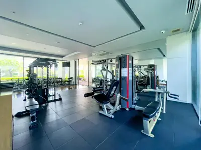 a gym with several tread machines in a room at Near BTS l Central Sukhumvit l Pool and Garden l Sontana in Bangkok