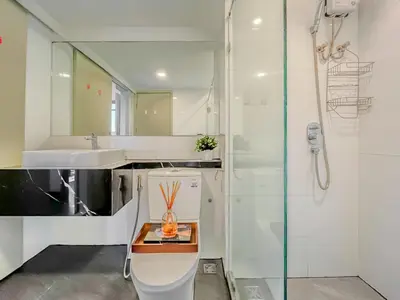 a bathroom with a toilet and a sink and a shower at Duplex near BTS l Rooftop Pool l Skyline l Sontana in Bangkok