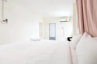 a bedroom with two white beds and a pink curtain at XX Oh My Nap - Sukhumvit 3 - โอ้มายแนป สุขุมวิท 3 in Makkasan