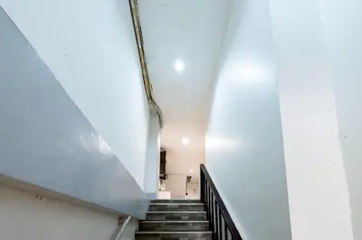 a staircase in a building with a white wall at XX Oh My Nap - Sukhumvit 3 - โอ้มายแนป สุขุมวิท 3 in Makkasan