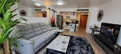 a living room with a couch and a tv at Newly renovated 1 bedroom condo NANA in Bang Kapi
