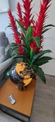 a vase with red flowers sitting on a table at Newly renovated 1 bedroom condo NANA in Bang Kapi