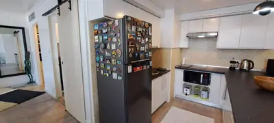a kitchen with a refrigerator with many magnets on it at Newly renovated 1 bedroom condo NANA in Bang Kapi