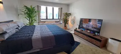 a bedroom with a bed and a flat screen tv at Newly renovated 1 bedroom condo NANA in Bang Kapi