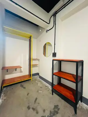a room with a mirror and shelves in it at Fit mansion in Sathani Sam Sen