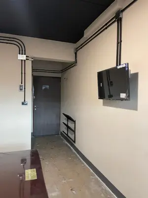 a flat screen tv hanging on the wall of a garage at Fit mansion in Sathani Sam Sen