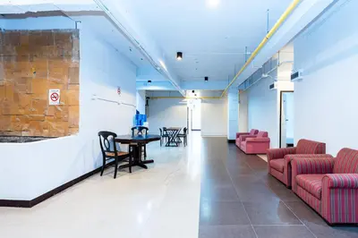 a lobby with chairs and a table in a building at XX The Hidden Khaosan - เดอะ ฮิดเด้น ถนนข้าวสาร in Bang Bua Thong Railway Station