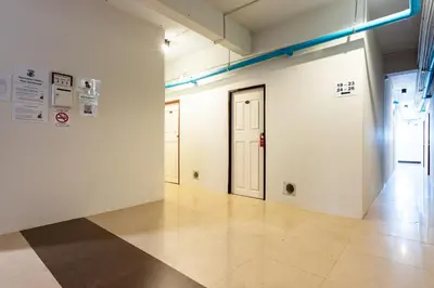 an empty room with a door and a tile floor at XX The Hidden Khaosan - เดอะ ฮิดเด้น ถนนข้าวสาร in Bang Bua Thong Railway Station