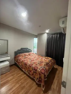 a bedroom with a bed in a room with a window at AC Home 2 Laksi in Lak Si