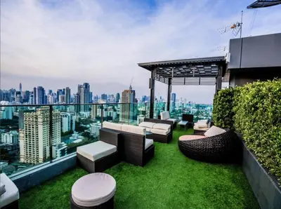 a rooftop garden with a view of the city at Free Airport Pick Up Rooftop Pool Gym near BTS Emquartier Shopping city center in Bangkok