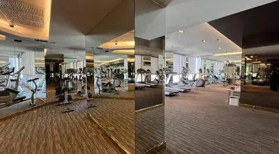 a gym with treadmills and ellipticals in a building at Free Airport Pick Up Rooftop Pool Gym near BTS Emquartier Shopping city center in Bangkok