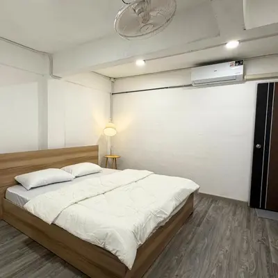 a bedroom with a large bed and a ceiling fan at Box me in Bangkok