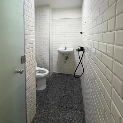 a bathroom with a toilet and a sink at Box me in Bangkok