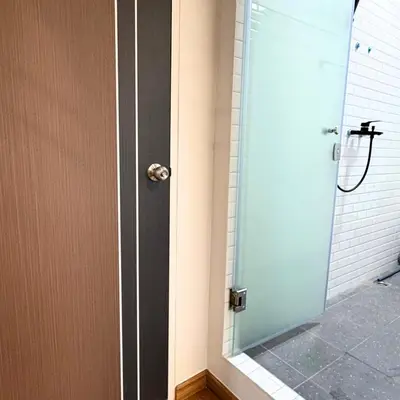 a shower with a glass door and a shower at Box me in Bangkok
