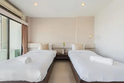 two beds in a room with a window at ZAYN Bangna Hotel in Bangna