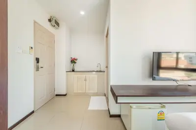 a white bathroom with a sink and a door at ZAYN Bangna Hotel in Bangna