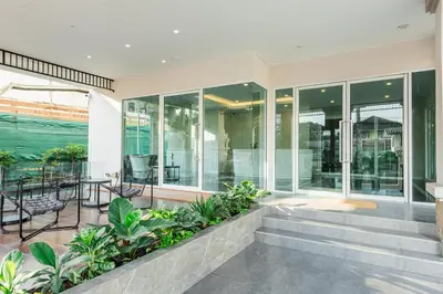 an internal view of a house with glass doors and a patio at ZAYN Bangna Hotel in Bangna