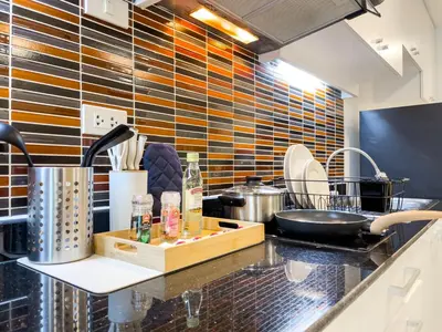a kitchen with a counter top with many appliances at BTS Thong Lol Large 52 sqm l Pool and Gym l Sontana in Bangkok