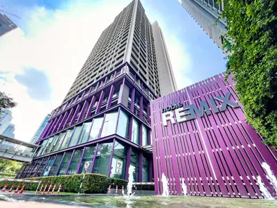 a tall building with a fountain in front of it at BTS Thong Lol Large 52 sqm l Pool and Gym l Sontana in Bangkok
