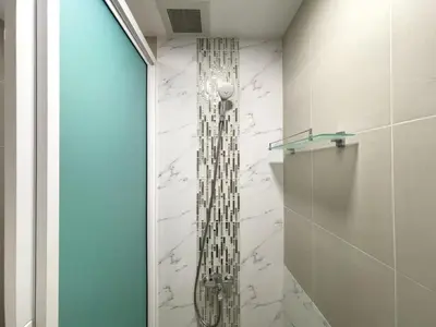 a shower in a bathroom with a glass shower head at BTS Thong Lol Large 52 sqm l Pool and Gym l Sontana in Bangkok