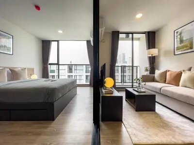 a bedroom with a bed and a couch at Near BTS - Near Iconsiam - Pool and Gym - Sontana in Bangkok