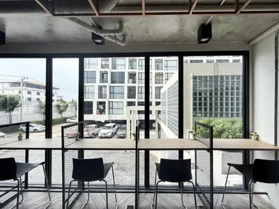 a room with tables and chairs and a large window at Near BTS - Near Iconsiam - Pool and Gym - Sontana in Bangkok