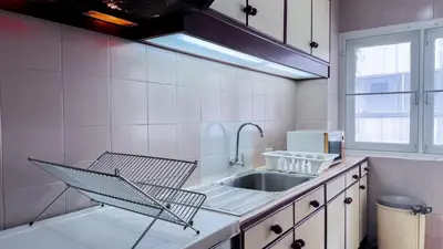 a kitchen with a sink and a faucet at Blissful Heaven Residence at BTS Phromphong Emdistrict Shopping Area in Bangkok