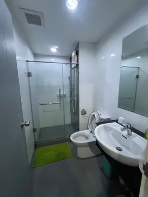 a bathroom with a shower and a toilet and a sink at AC Home 1 Laksi in Lak Si