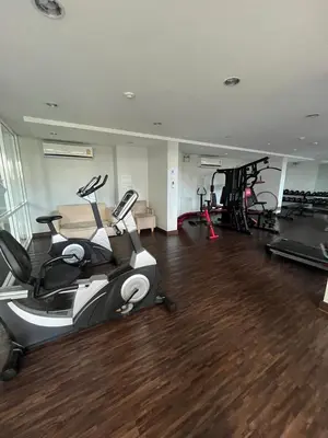 a gym with treadmills and exercise bikes in a room at AC Home 1 Laksi in Lak Si