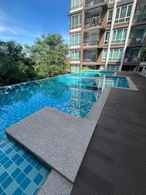 a swimming pool in front of a building at AC Home 1 Laksi in Lak Si