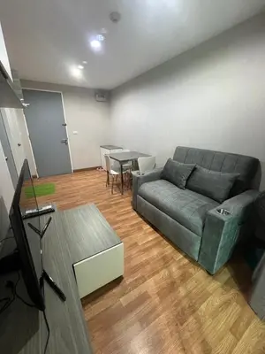 a living room with a couch and a table at AC Home 1 Laksi in Lak Si