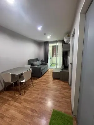 a living room with a table and a couch at AC Home 1 Laksi in Lak Si