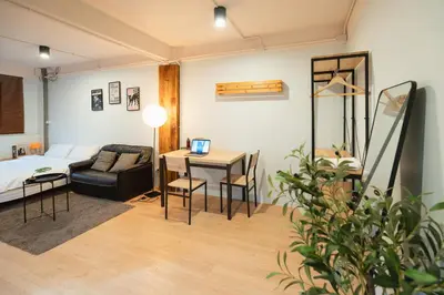 a room with a bed and a table with a couch at Dec room at bangsue in Bang Su