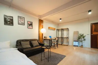 a room with a bed and a couch and a table at Dec room at bangsue in Bang Su