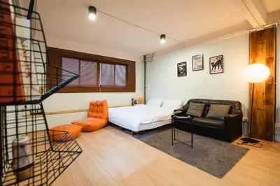 a bedroom with a bed and a couch and a chair at Dec room at bangsue in Bang Su