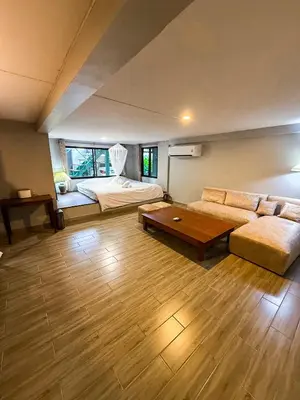 a large living room with a couch and a bed at Pridi cozy home with good location Type A in Bangkok
