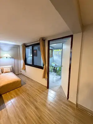 a bedroom with a bed and a sliding glass door at Pridi cozy home with good location Type A in Bangkok