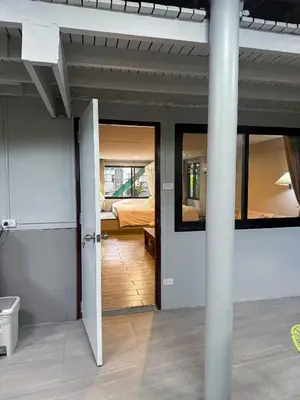 a room with a door open to a bedroom at Pridi cozy home with good location Type A in Bangkok