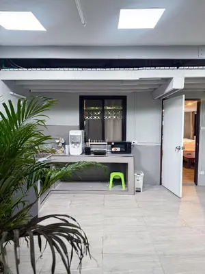 an office with a desk and a green chair at Pridi cozy home with good location Type A in Bangkok