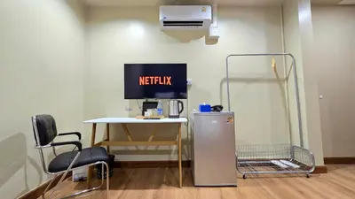 a room with a heater and a table and a refrigerator at Postel Chinatown in Bangkok