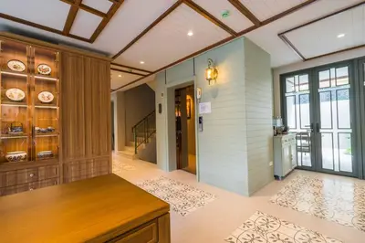 a large kitchen with wood paneling and a ceiling at TUAN Hotel Bangkok in Bangkok Yai