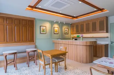 a kitchen with a table and chairs and a counter at TUAN Hotel Bangkok in Bangkok Yai