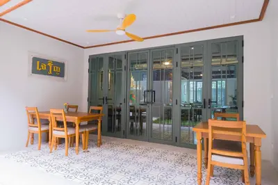a dining room with a table and chairs at TUAN Hotel Bangkok in Bangkok Yai