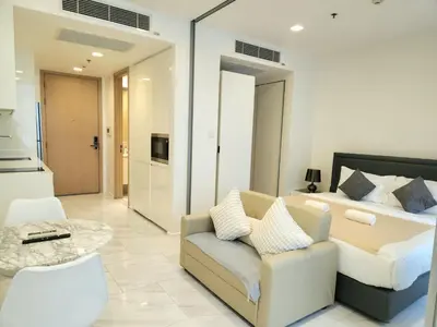 a bedroom with a bed and a couch and a table at Prime 1BR in Sukhumvit 11 CentralStylishModern in Makkasan