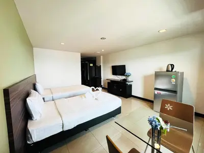 a hotel room with a bed and a refrigerator at 14 Place in Bangkok